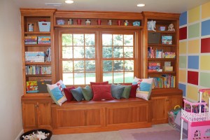 Built toy and book storage around a basement window. Window seat has more storage.    